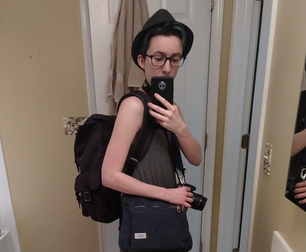 Me taking a mirror selfie with my full backpack on, purse comfortable at my side, and camera around my neck. I'm carrying a lot, but it doesn't look like it!